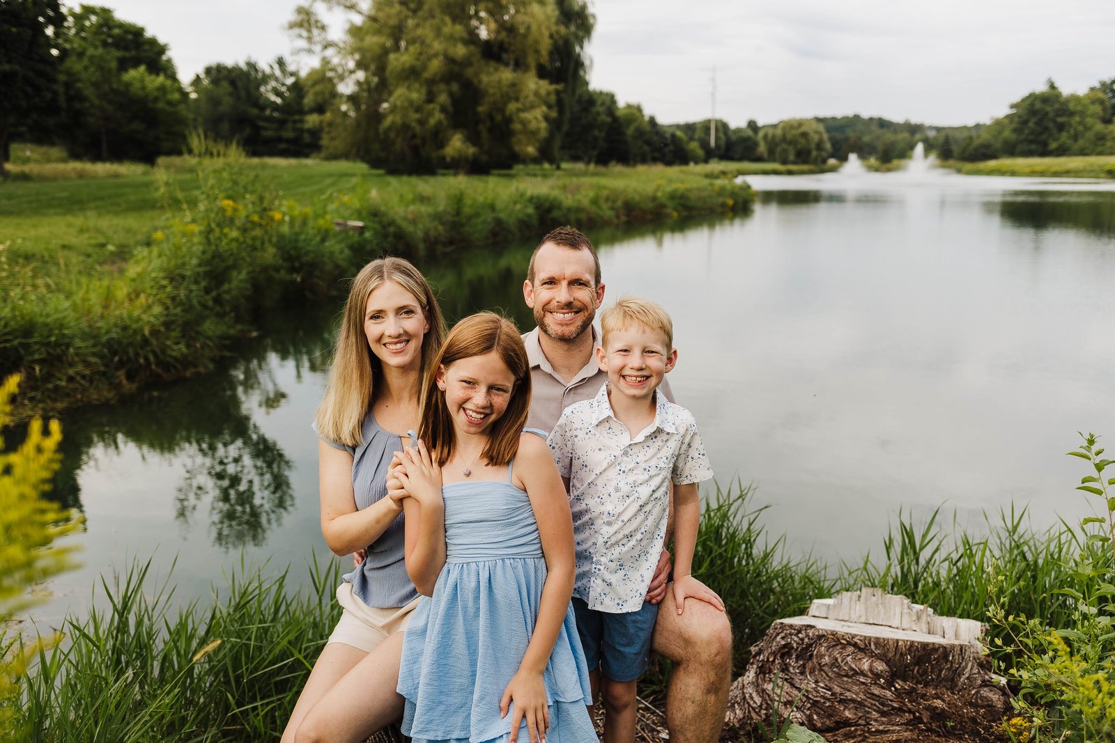 Family standing together beside a lake